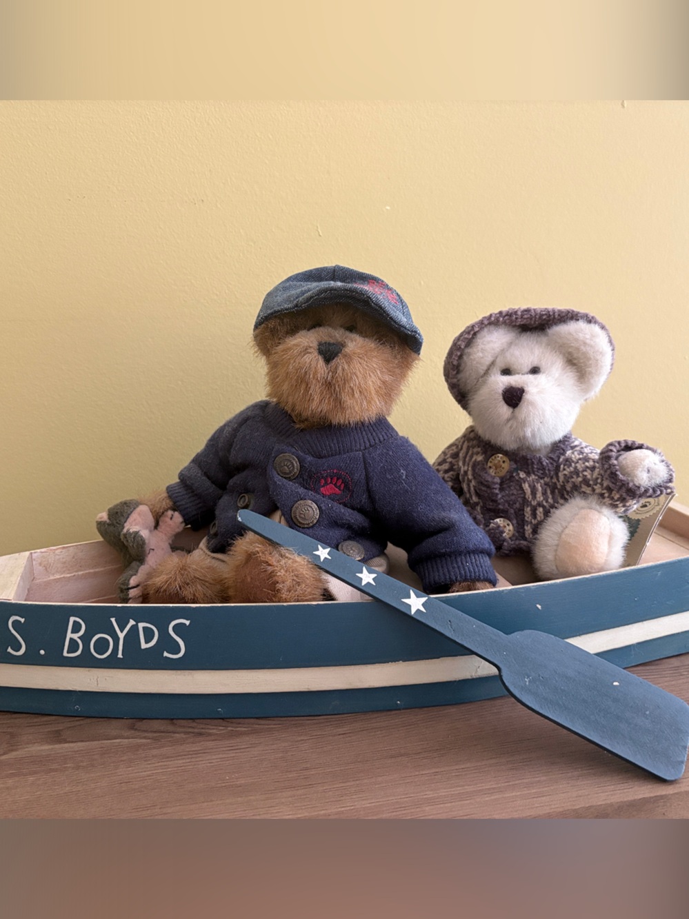 Boyd’s Bear collection with painted wooden rowboat.